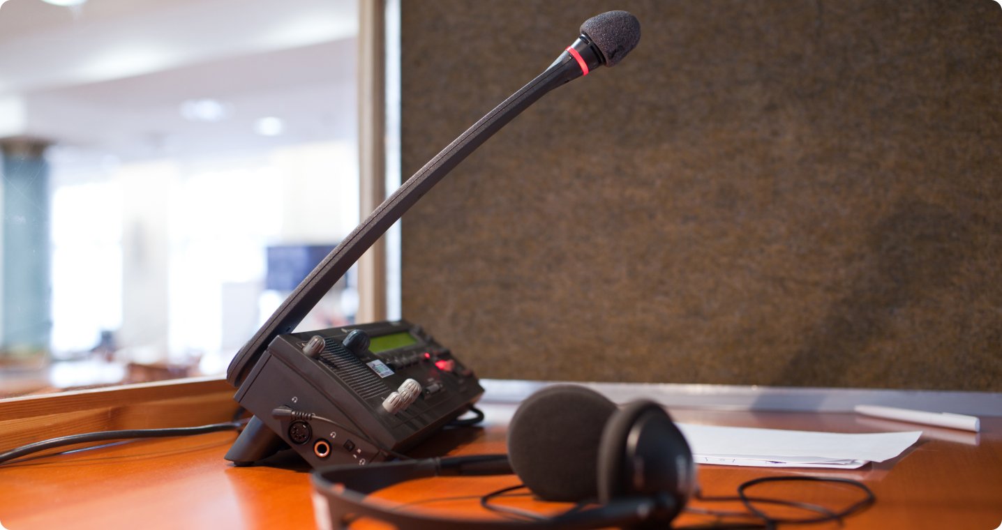 Bosch interpreter console, microphone, and headphone in a soundproof interpretation booth