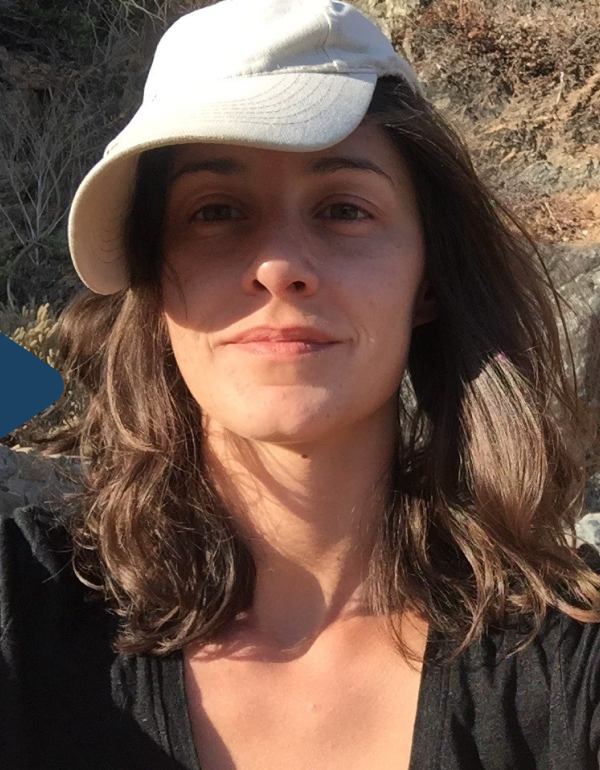 Aurora: headshot of English and Spanish interpreter and filmmaker, Aurora, wearing a cap