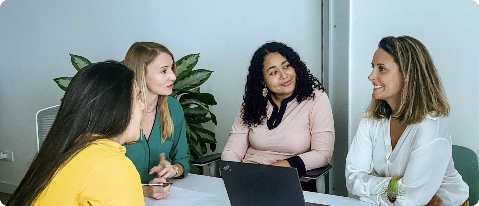 four women discuss translation project at interpretingCO's office in Cartagena, Colombia