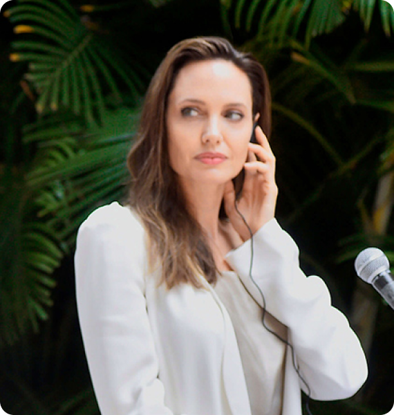 Jolie: Angelina Jolie wears earphones to listen to Spanish to English simultaneous interpretation in Cartagena, Colombia